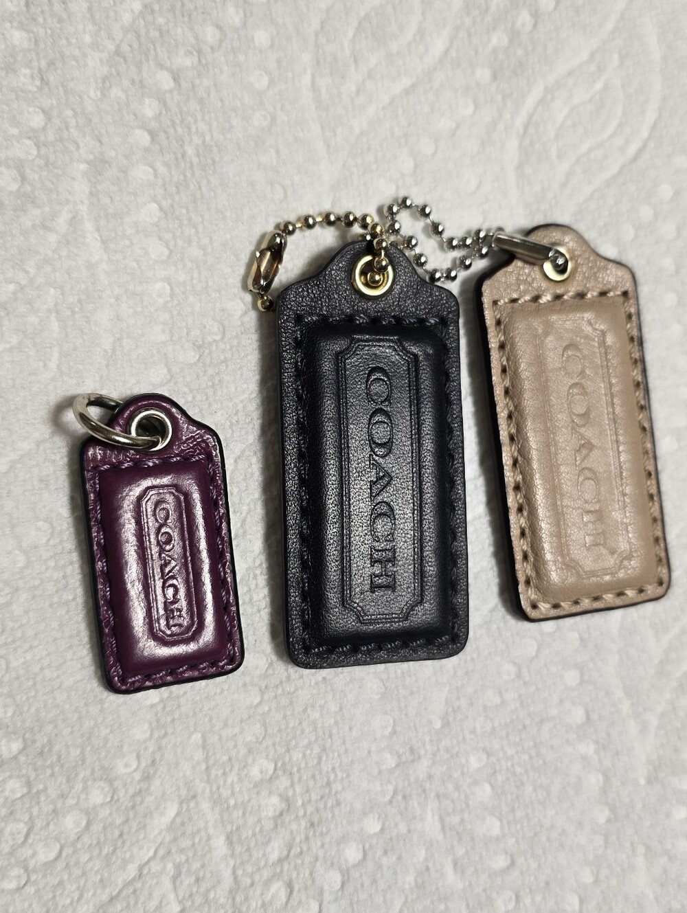 Coach Leather Tag Trio in Plum, Black, and Light Taupe